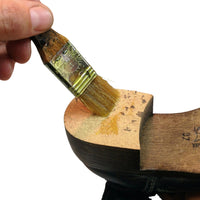 hand-holding-glue-brush-applying-glue-to-shoe-sole