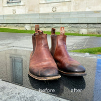 Before and after R.M. Williams boots resoled by Shane's Shoe Repairs, photographed outside the Auckland Museum showing restored leather and new soles.